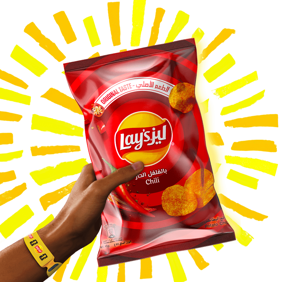 Hand holding a bag of Lay's chili chips